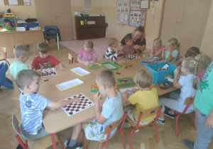 Grupa dzieci grająca w warcaby