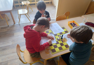 dzieci patrzą na karty pracy