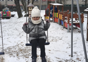 Dziewczynka huśta się na huśtawce