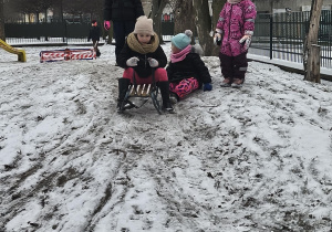 Dzieci zjeżdżają nz sankach