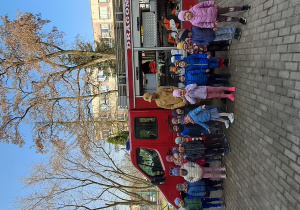 dzieci pozują do zdjęcia przed wozem strażackim