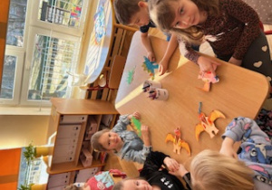 Dzieci siedzą przy stoliczku