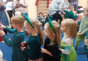 Dzieci odświętnie ubrane śpiewają dla gości piosenki świąteczne.